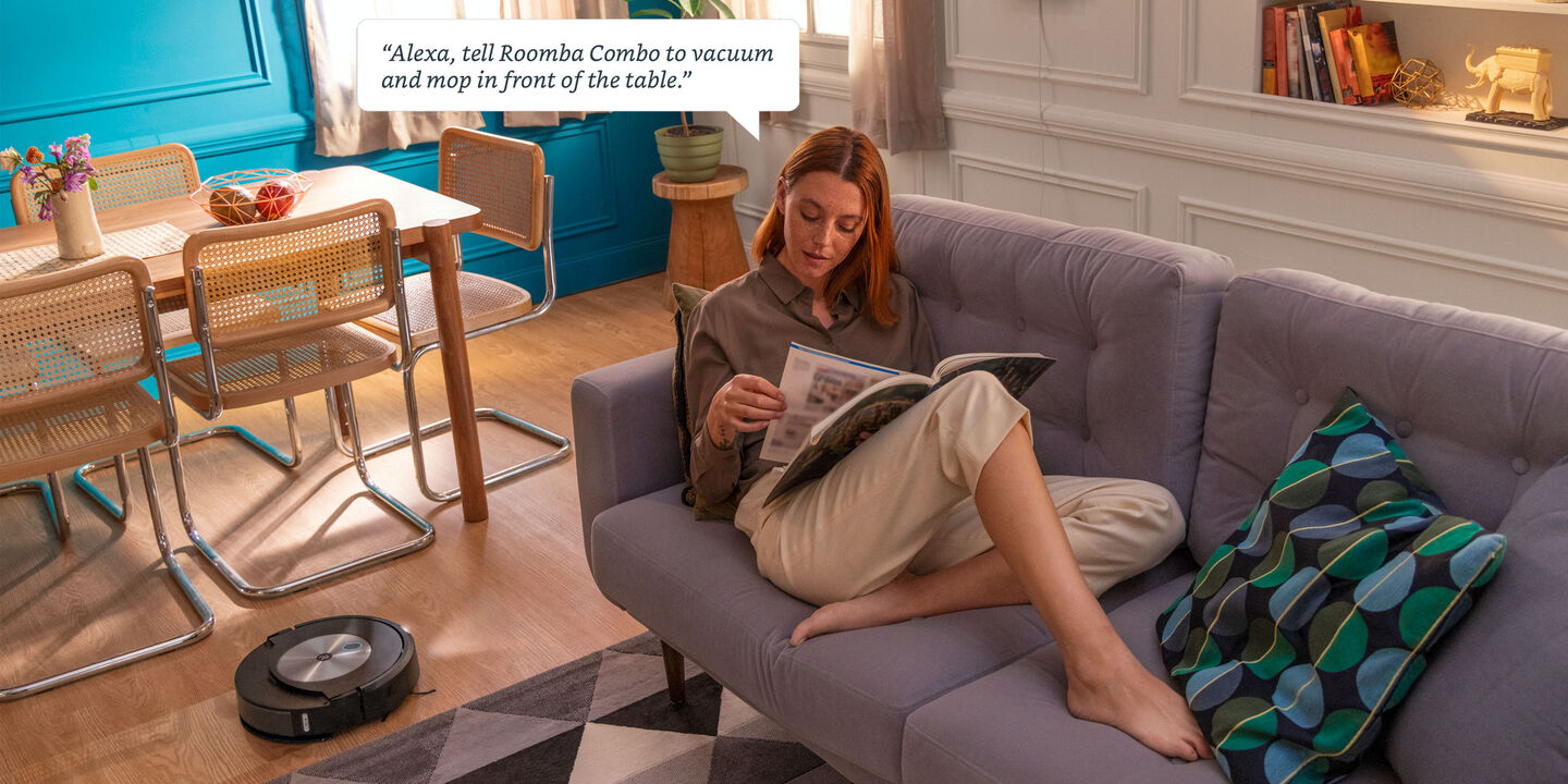 Woman reading with roomba combo cleaning