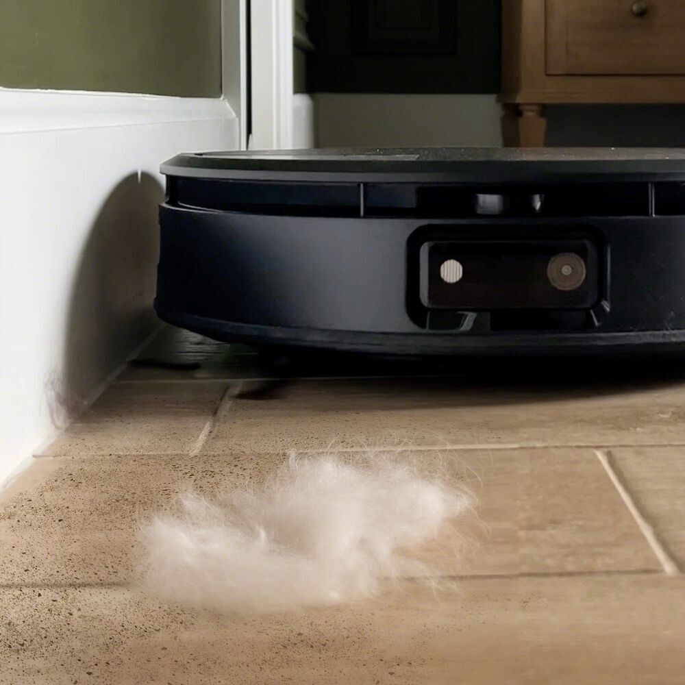 A Roomba&reg; robot approaching pet hair to clean up
