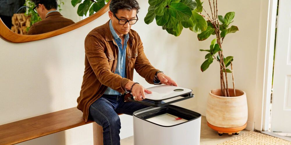 Man replacing filter on Aeris Air Purifier