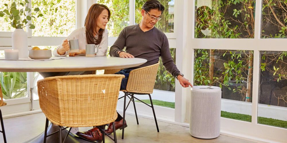 Man and woman turning on Aeris Air Purifier